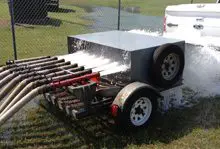 A trailer with a large metal box on it.